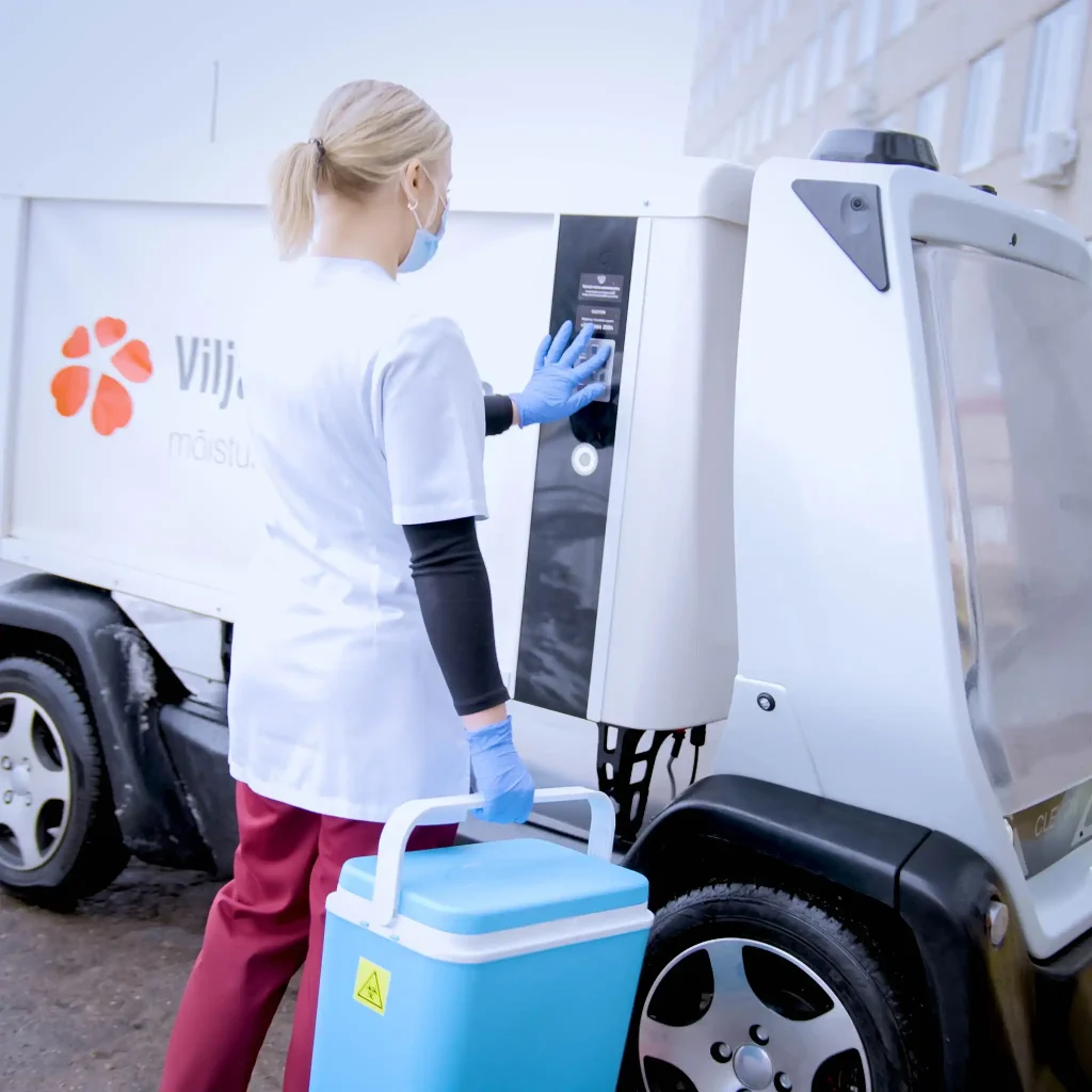 Nurse placing samples in autonomous robot