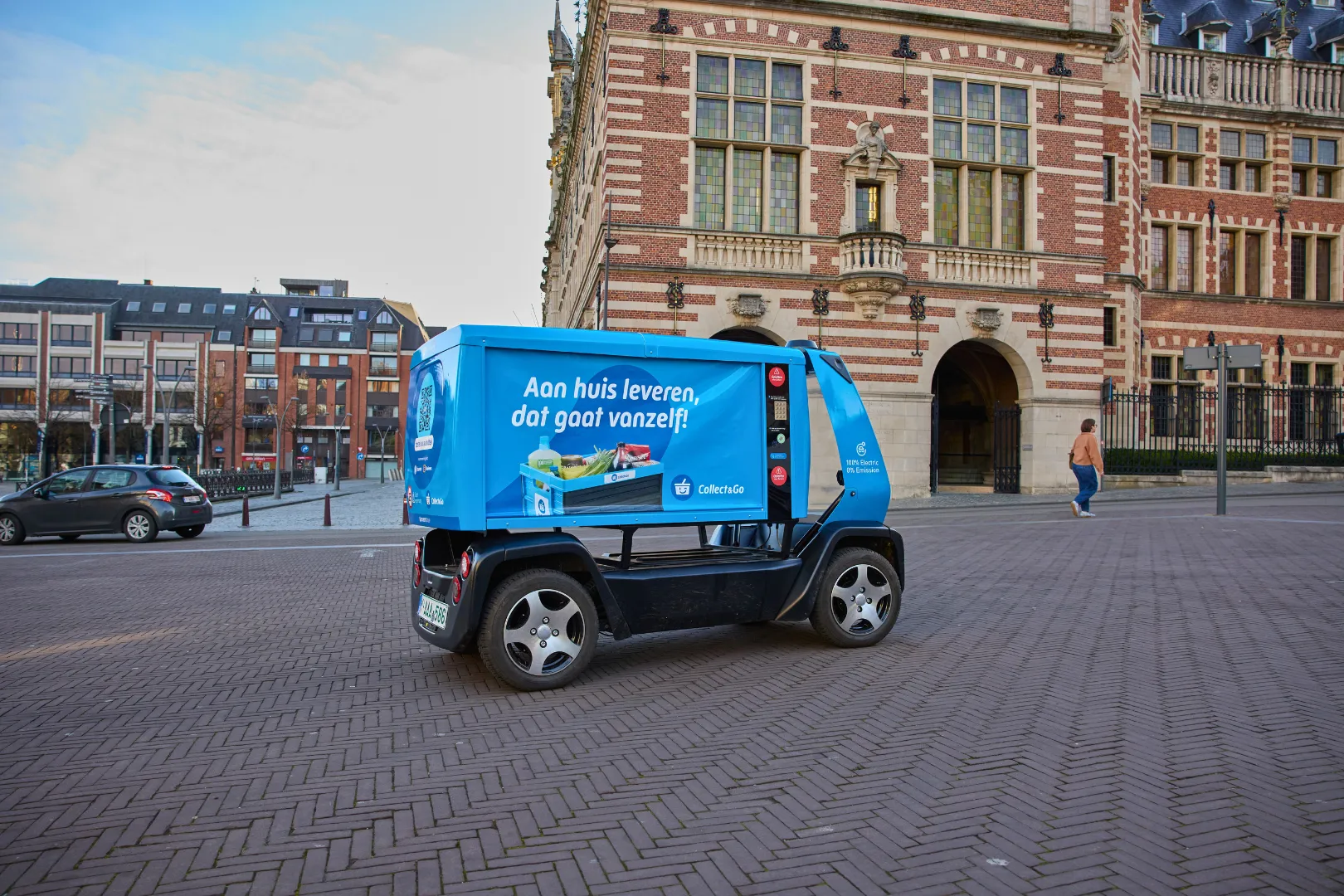 GO Bot autonomous delivery vehicle navigating a public square in Leuven Belgium surrounded by historic buildings