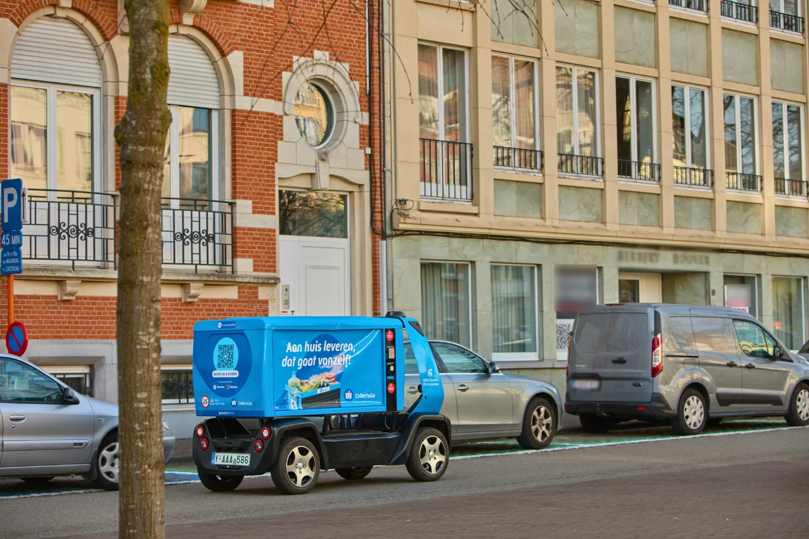 GO Bot electric delivery vehicle driving on a city street in Leuven Belgium during real-world last-mile operations